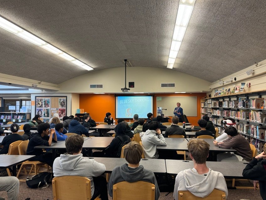 Students sitting in library listening to inventor speak about bluetooth technology