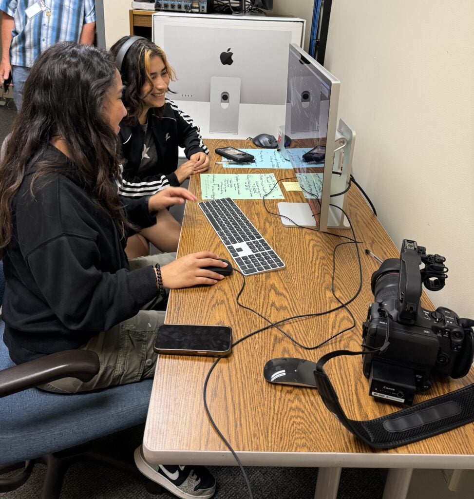 students collaborating on media arts work