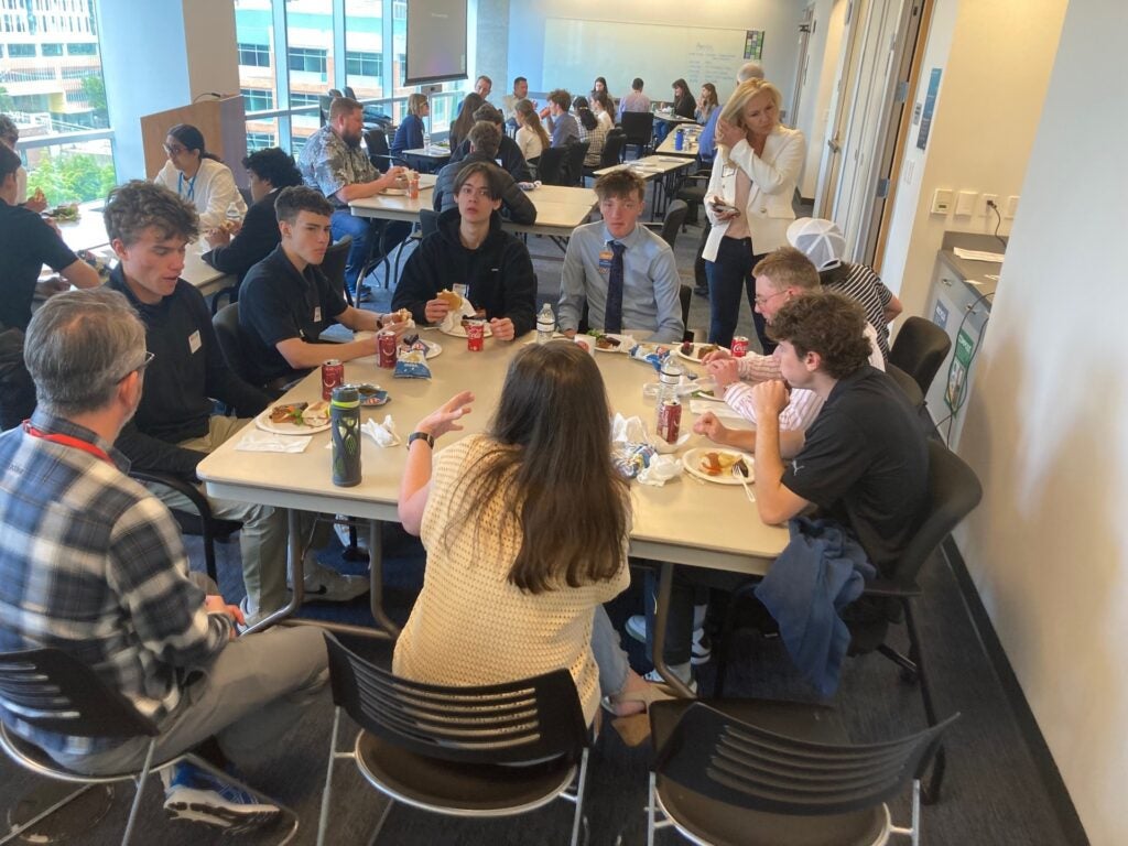 students sitting around table for networking activity
