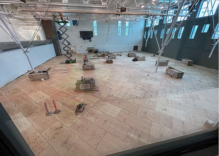 a gymnasium with plywood floor